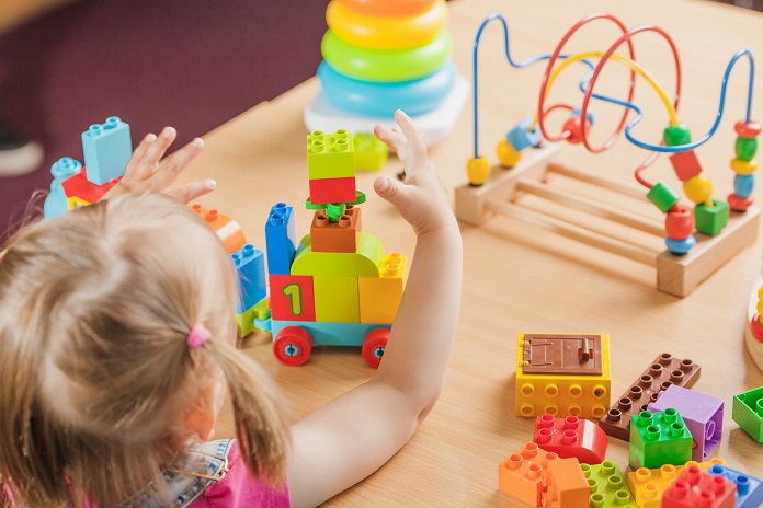 girl plays with educational toys