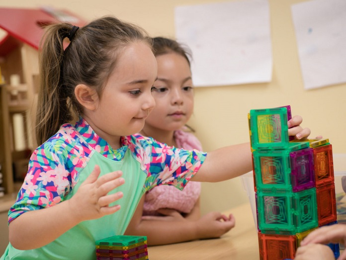 2 kids playing with educational toys