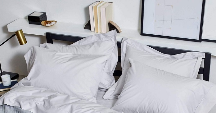 bed pillows and shelf with books