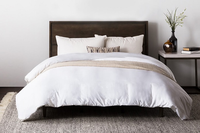 brown bed with white sheets