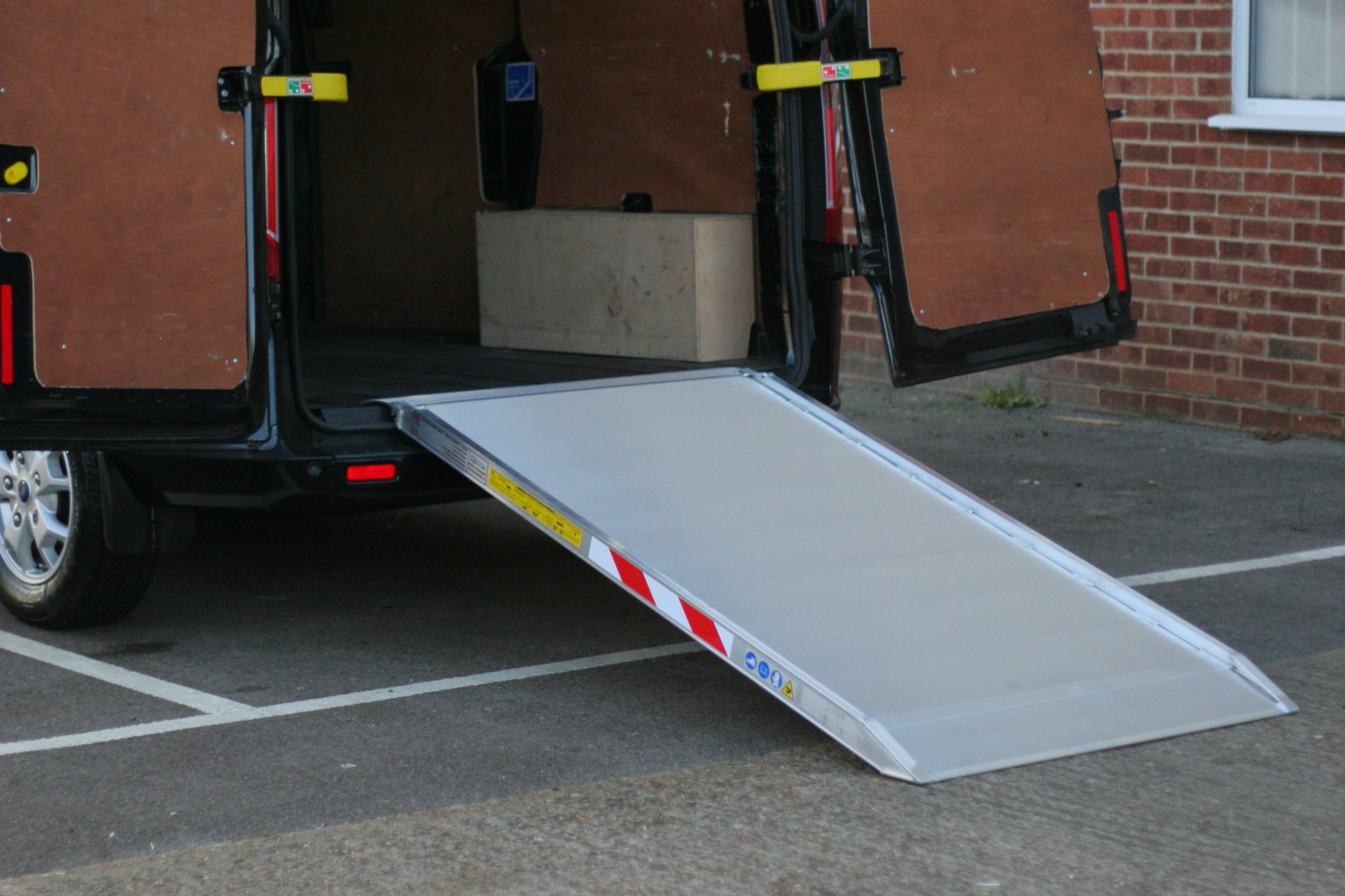 An easy-to-lift ramp that can be slid quickly into position when needed and permanently stowed away in your van gives you maximum flexibility for any occasion. It does away with the need to recruit extra hands to help with loading and unloading jobs that could ordinarily be handled by one person; and the same ramp can even be used to negotiate curbs, steps, and other features that can be just as challenging as loading your vehicle. Most importantly though, loading ramps for vans help to eliminate the risk of material damage and personal injury that can occur when you're lifting and transporting heavy objects.