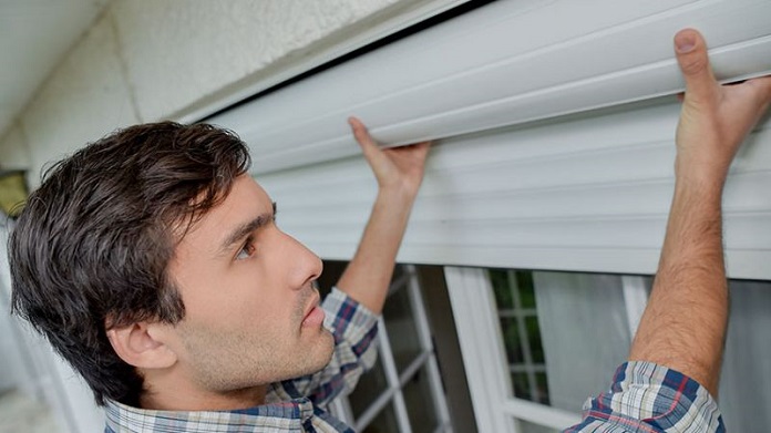 a man installing roller shutters