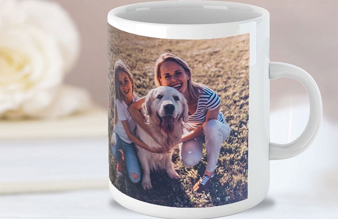 close up of a mug with a photo on it of a mom, daughter, and her dog