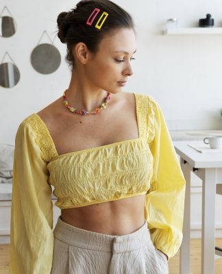 woman wearing a yellow crop top with long sleeves