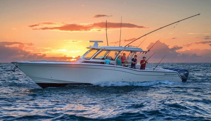 A beautiful white boat with people fishing at sunset, illustrating the ideal marine lifestyle supported by reliable marine batteries.