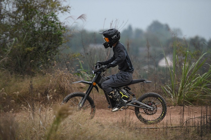 man riding electric motorcycle in nature