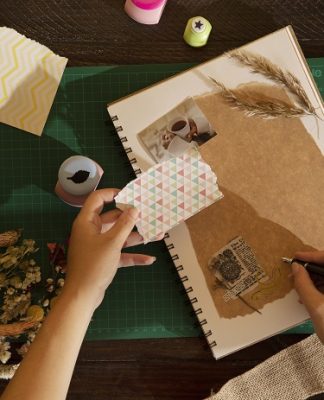 woman scrapbooking at home